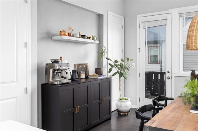 bar with dark hardwood / wood-style flooring