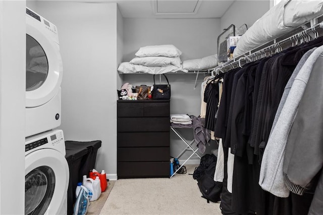 washroom featuring stacked washer / dryer and carpet flooring