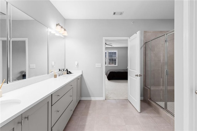 bathroom featuring ceiling fan, tile patterned flooring, vanity, and walk in shower