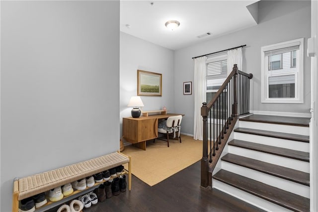 stairs featuring hardwood / wood-style floors