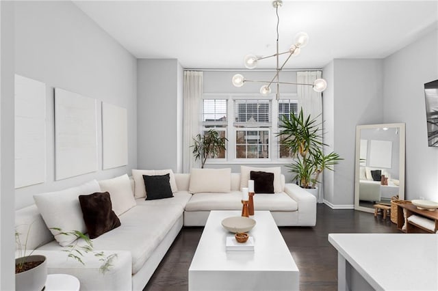 living room featuring dark hardwood / wood-style floors and an inviting chandelier