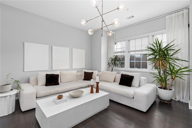 living room featuring dark hardwood / wood-style flooring and a chandelier