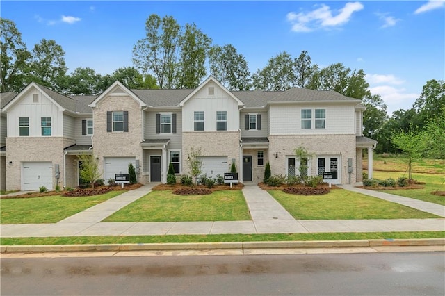 multi unit property with board and batten siding, a front yard, and a garage