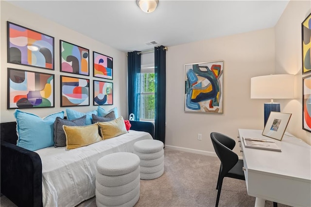carpeted bedroom with baseboards and an office area