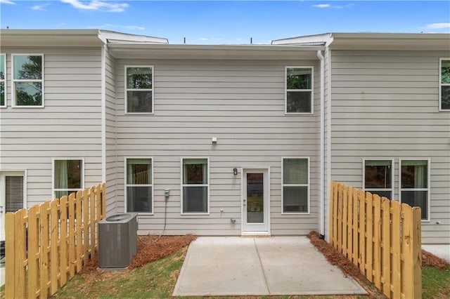 back of house featuring a patio area, fence, and cooling unit