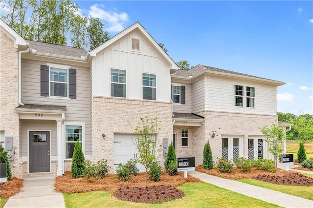townhome / multi-family property with an attached garage, board and batten siding, brick siding, and central AC unit