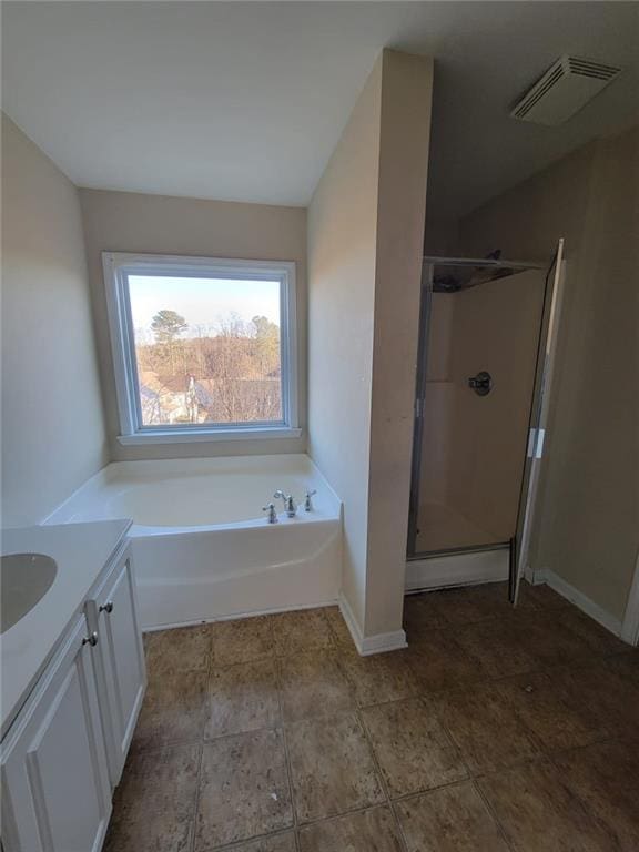 full bath featuring visible vents, baseboards, a garden tub, vanity, and a shower stall