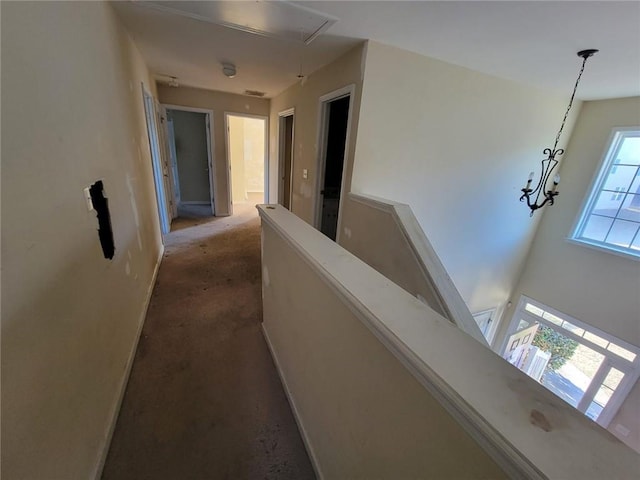 corridor with attic access and an upstairs landing