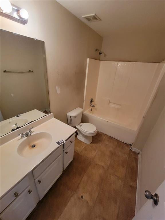 bathroom featuring toilet, bathing tub / shower combination, vanity, and visible vents