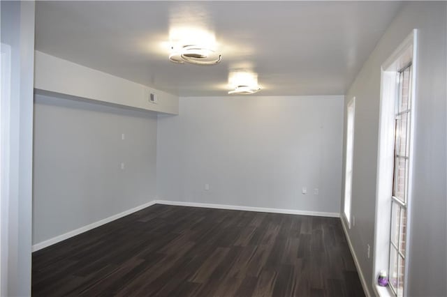 empty room featuring dark wood-type flooring