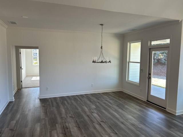 unfurnished dining area with dark wood finished floors, visible vents, a chandelier, and crown molding