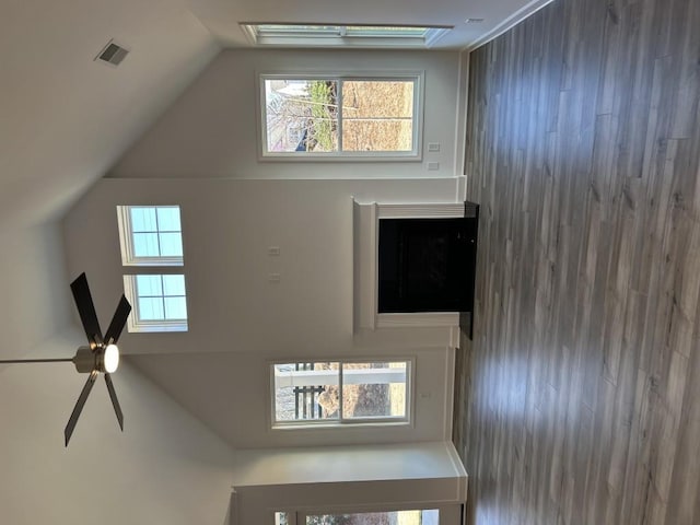 interior space with vaulted ceiling and visible vents