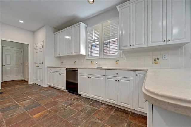 kitchen with black dishwasher, white cabinets, and decorative backsplash