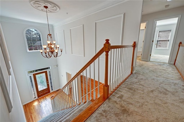 interior space featuring crown molding, a notable chandelier, and light hardwood / wood-style floors