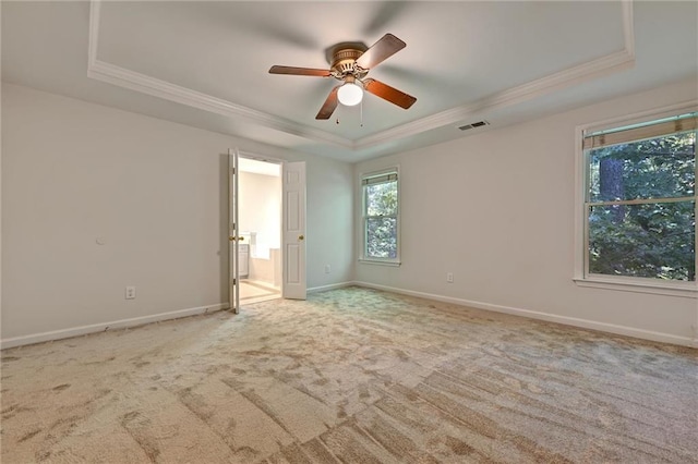 unfurnished room featuring ornamental molding, a raised ceiling, and ceiling fan