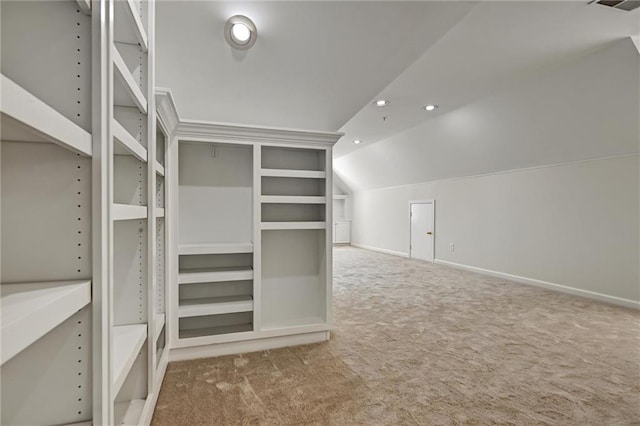 walk in closet featuring lofted ceiling and carpet