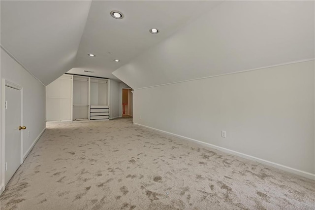 additional living space with lofted ceiling and light colored carpet