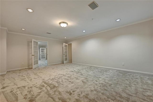 unfurnished room with light colored carpet, ornamental molding, and french doors