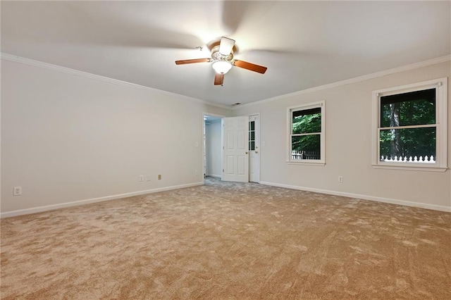 spare room with crown molding, ceiling fan, and light carpet