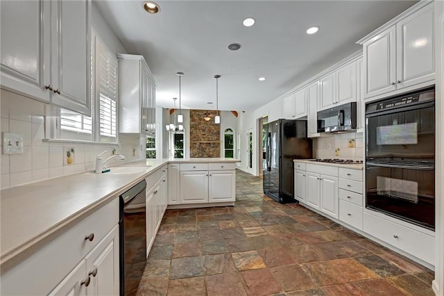 kitchen featuring black appliances, white cabinetry, sink, and decorative backsplash