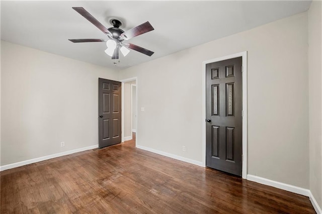 empty room featuring dark hardwood / wood-style floors and ceiling fan