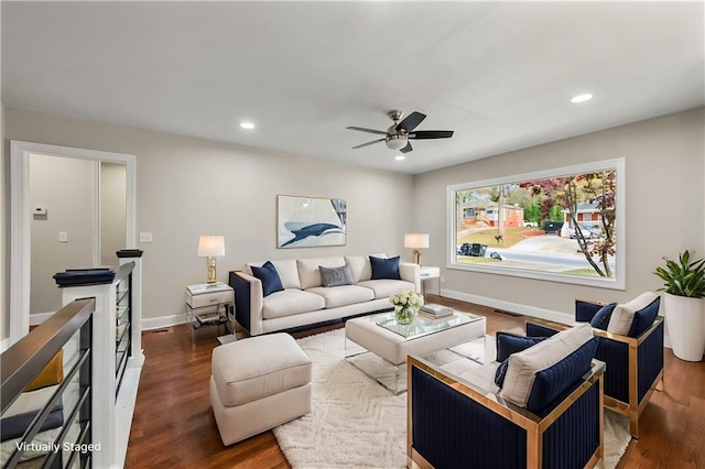 living room featuring dark hardwood / wood-style flooring and ceiling fan