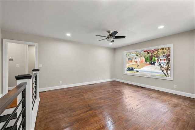 interior space featuring dark wood-type flooring and ceiling fan