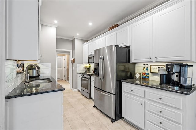 139 Mountain Vista Blvd, Canton, GA 30115 - kitchen featuring appliances with stainless steel finishes, a sink, crown molding, decorative backsplash, and white cabinets