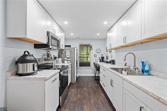 139 Mountain Vista Blvd, Canton, GA 30115 - kitchen with stainless steel appliances, a sink, dark wood finished floors, recessed lighting, and white cabinetry