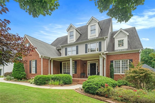 4653 Glory Maple Trce, Powder Springs, GA 30127 - view of front of property with brick siding, a porch, a front yard, and roof with shingles