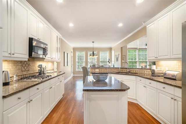 4653 Glory Maple Trce, Powder Springs, GA 30127 - kitchen featuring appliances with stainless steel finishes, light wood finished floors, white cabinetry, a kitchen island, and recessed lighting
