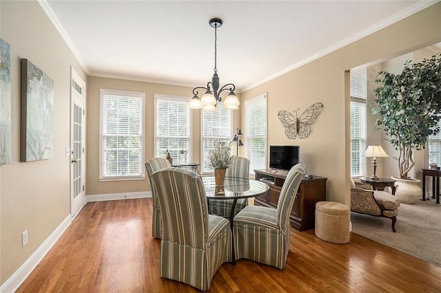 4653 Glory Maple Trce, Powder Springs, GA 30127 - dining space featuring a chandelier, wood finished floors, and ornamental molding