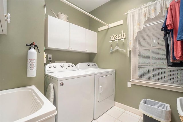4653 Glory Maple Trce, Powder Springs, GA 30127 - laundry area featuring washer and clothes dryer, cabinet space, and light tile patterned floors