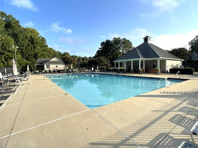 4653 Glory Maple Trce, Powder Springs, GA 30127 - community pool featuring a patio and view of scattered trees