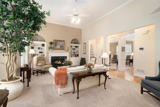 4653 Glory Maple Trce, Powder Springs, GA 30127 - living area featuring ornamental molding, plenty of natural light, a ceiling fan, a premium fireplace, and built in features