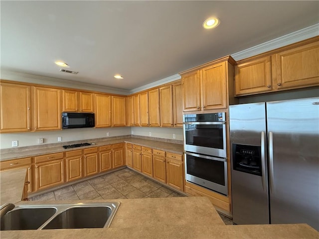 kitchen with visible vents, recessed lighting, a sink, black appliances, and light countertops