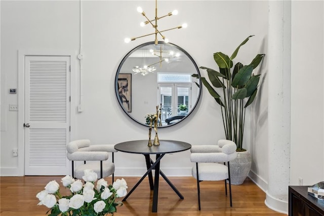 1058 Piedmont Ave Unit 103, Atlanta, GA 30309 - living area featuring a chandelier, wood finished floors, and baseboards
