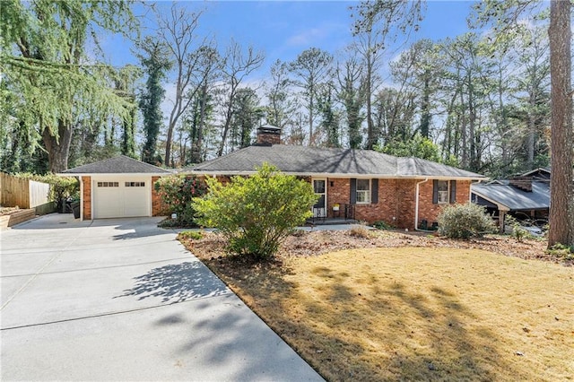 single story home featuring brick siding, a chimney, concrete driveway, an attached garage, and fence