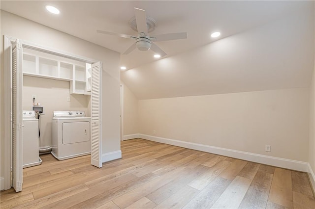 laundry area with ceiling fan, washer and clothes dryer, and light hardwood / wood-style floors