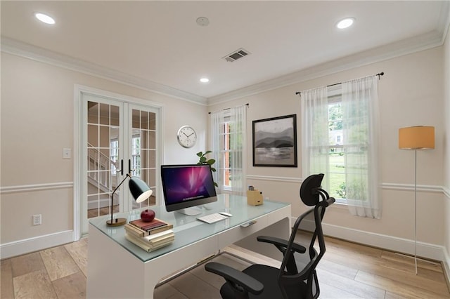 home office featuring ornamental molding, french doors, and light wood-type flooring