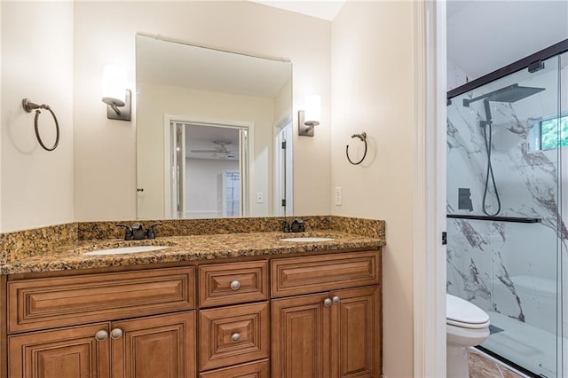 bathroom with toilet, vanity, and an enclosed shower