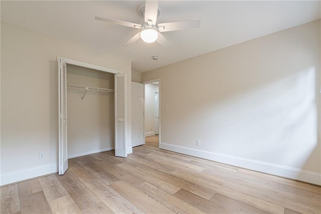 unfurnished bedroom featuring light hardwood / wood-style floors, a closet, and ceiling fan