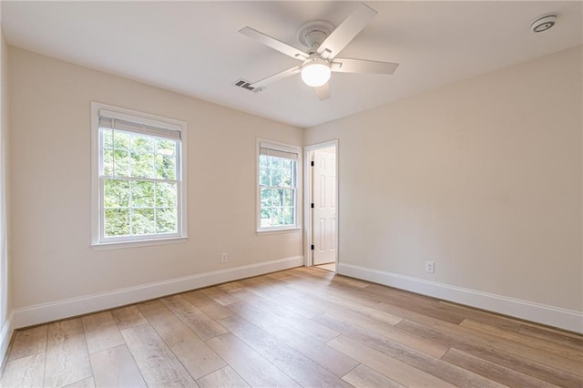 unfurnished room with light wood-type flooring and ceiling fan