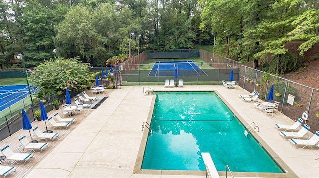 view of pool featuring a diving board