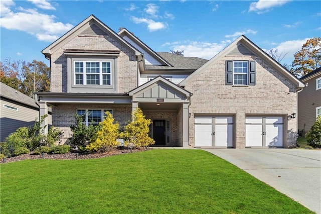 view of front of home featuring a front yard and a garage