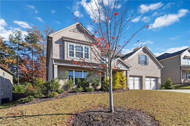 view of property with a front yard and a garage