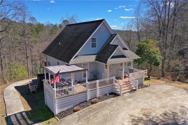 rear view of house featuring a porch