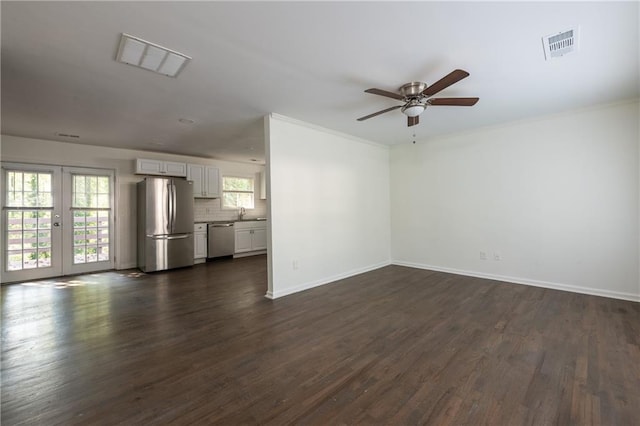 unfurnished living room featuring french doors, ceiling fan, sink, and dark wood-type flooring