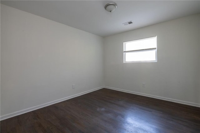 spare room featuring dark hardwood / wood-style floors