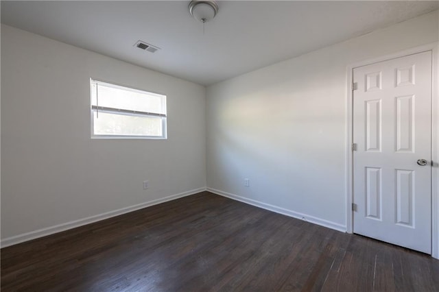 spare room featuring dark hardwood / wood-style floors